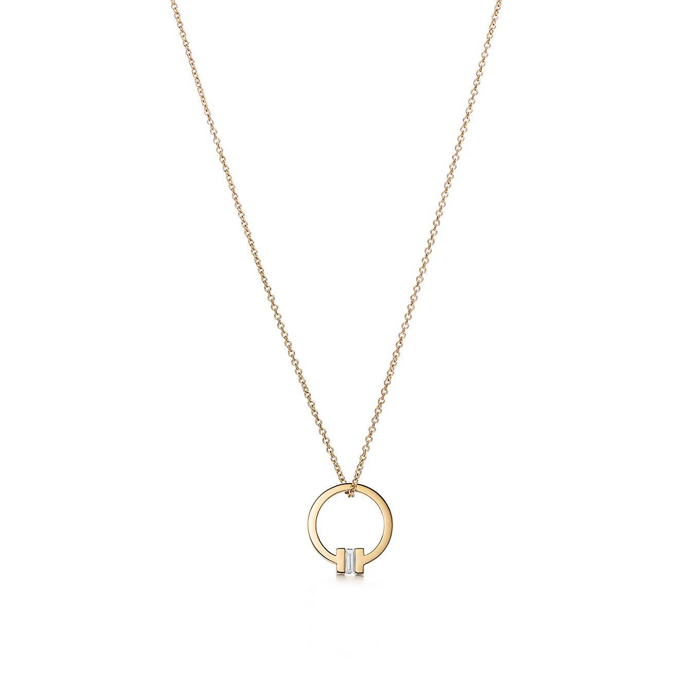 T*f*ny t pendant in 18k gold with a baguette diamond