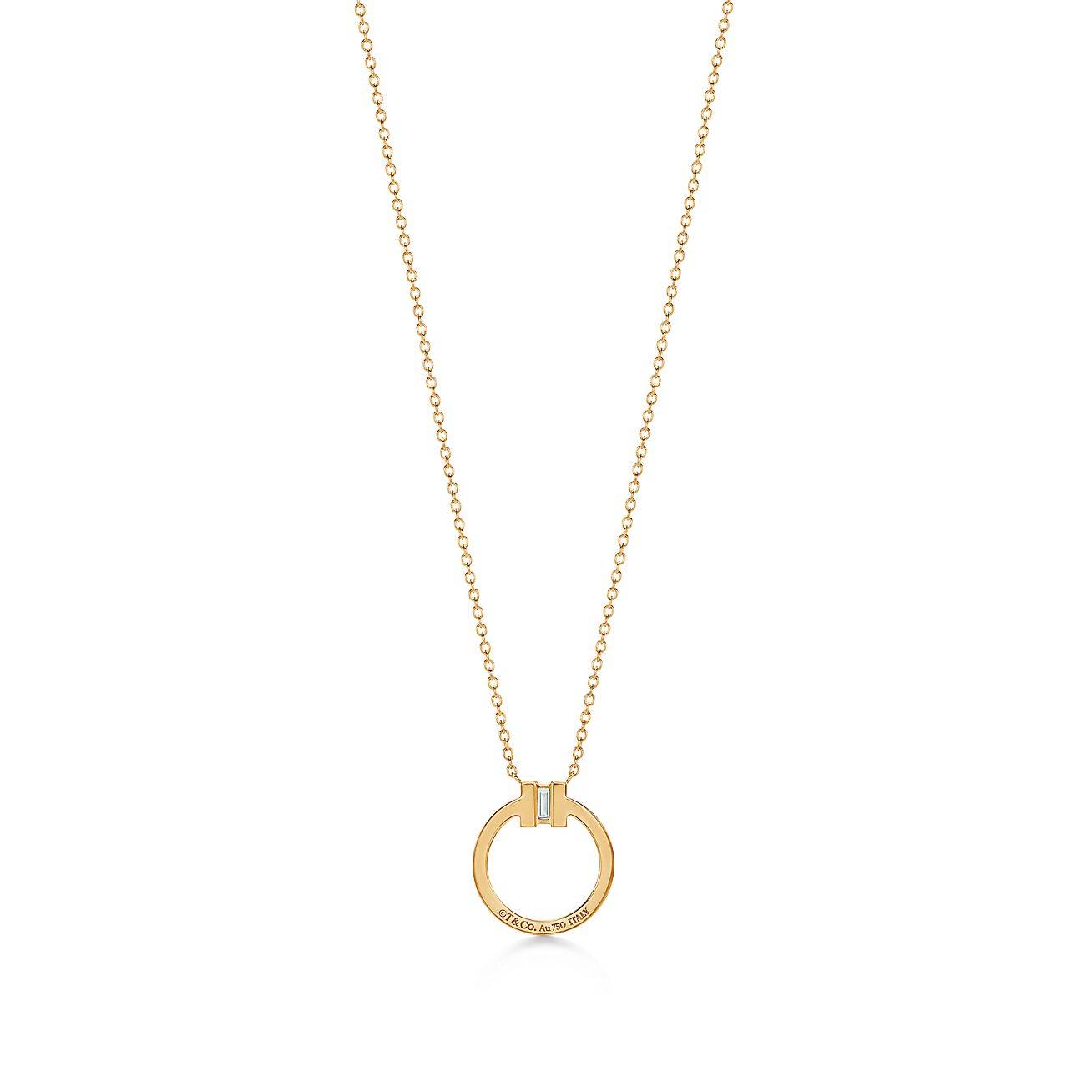 T*f*ny t diamond pendant in 18k gold with a baguette diamond